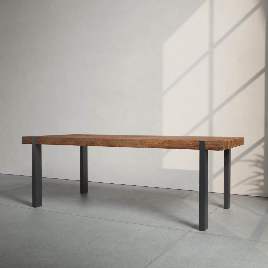 A Beam Dining Table with metal legs stands in a sunlit, minimalist room with smooth, light-colored walls and a large window casting shadows on the floor.