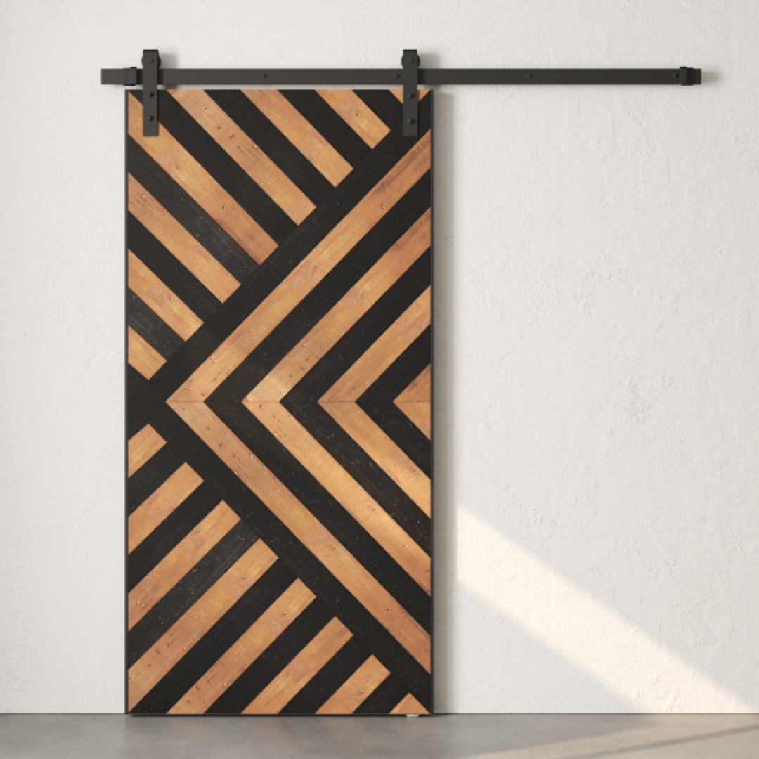 The Enigma Reclaimed Wood Barn Door Espresso features a geometric pattern of black and natural wood stripes, mounted on a sleek black metal rail against a plain white wall.