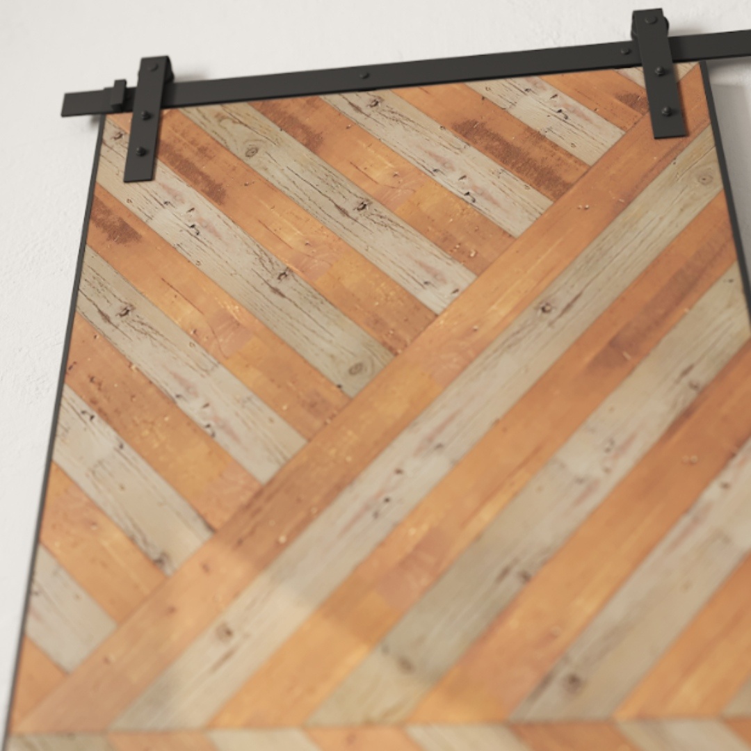 Enigma Reclaimed Wood Barn Door Grey with a chevron pattern made of alternating light and dark wooden strips, mounted on black sliding hardware against a white wall.