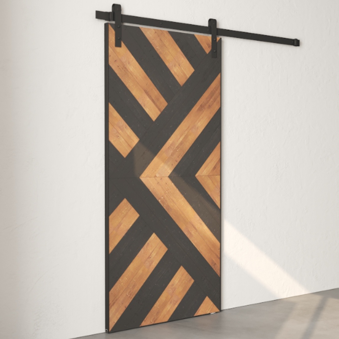 A Lumina Reclaimed Wood Barn Door Espresso with a geometric pattern of diagonal black and wooden planks, mounted on a black track system against a white wall.