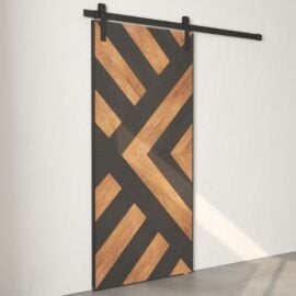 A Lumina Reclaimed Wood Barn Door Espresso with a geometric pattern of diagonal black and wooden planks, mounted on a black track system against a white wall.