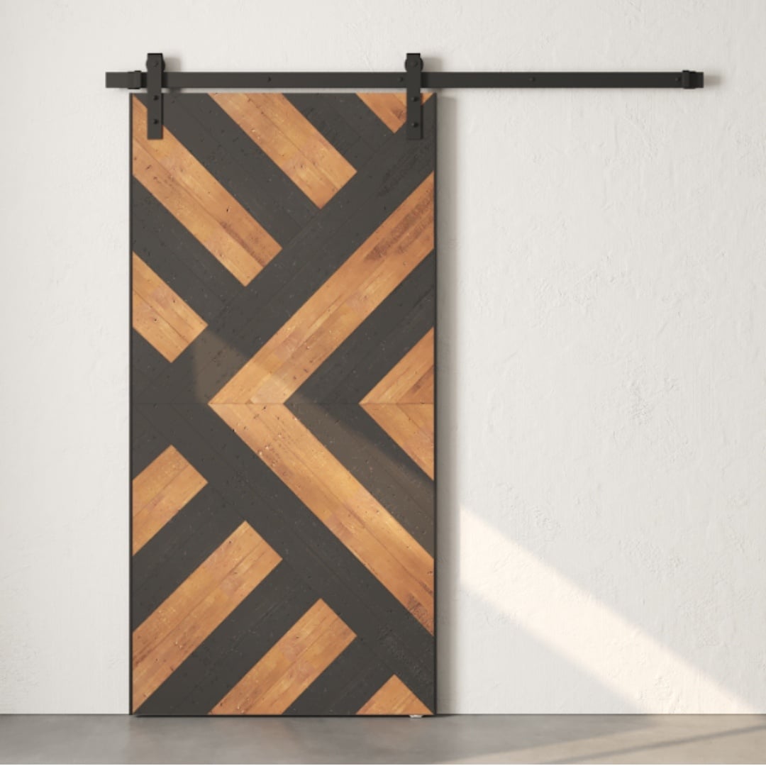 The Lumina Reclaimed Wood Barn Door Espresso features diagonal geometric patterns in dark and light wood tones and is mounted on a sliding metal track.