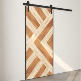 The Lumina Reclaimed Wood Barn Door White with a chevron pattern hangs on a black metal sliding track against a plain white wall.