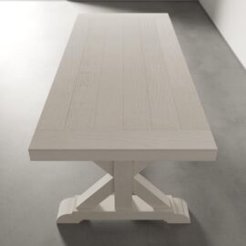 A Madera Dining Table - Pure White with a rectangular top and a sturdy, cross-stretcher base, placed on a light grey floor.