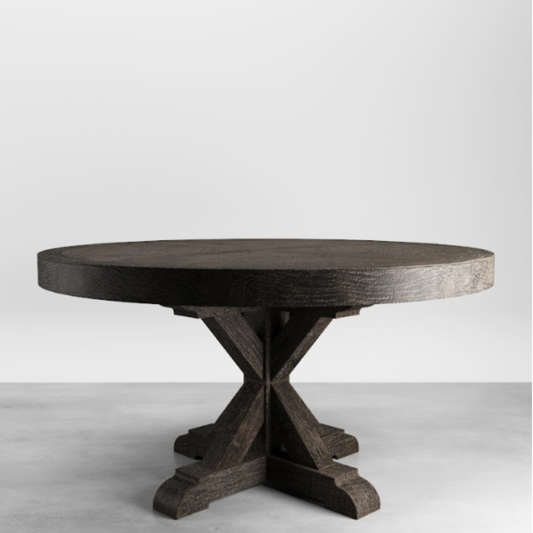 The Madera Round Table boasts a dark finish and a sturdy, cross-shaped base, perfect for adding elegance to any space. It stands on a gray surface against a plain white background, making it an ideal centerpiece for your Café Noire.