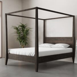 A Riviera Bed (Café Noire) with white bedding stands in a minimalistic room with a potted plant in the corner.