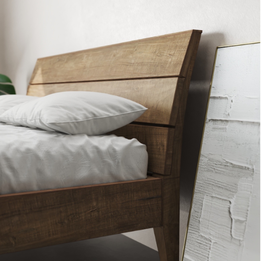 Tuscan Bed Natural King _ Queen - 3 A Tuscan Bed (Natural) adorned with a white mattress and pillows, positioned beside a mirror with a textured white-painted frame, leaning against the wall.