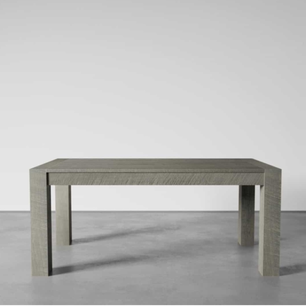 A Villa Dining Table - Rustic Grey, characterized by its simple rectangular wooden design, sits elegantly in a minimalistic room with a concrete floor and plain white walls.