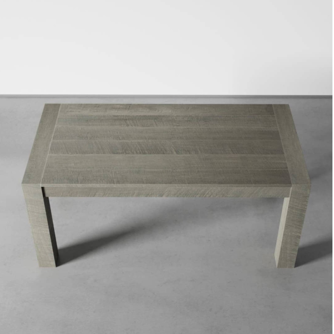 Villa Dining Table ( Bleached Grey) 60 - 2 A Villa Dining Table in Rustic Grey is positioned on a grey floor against a white wall.
