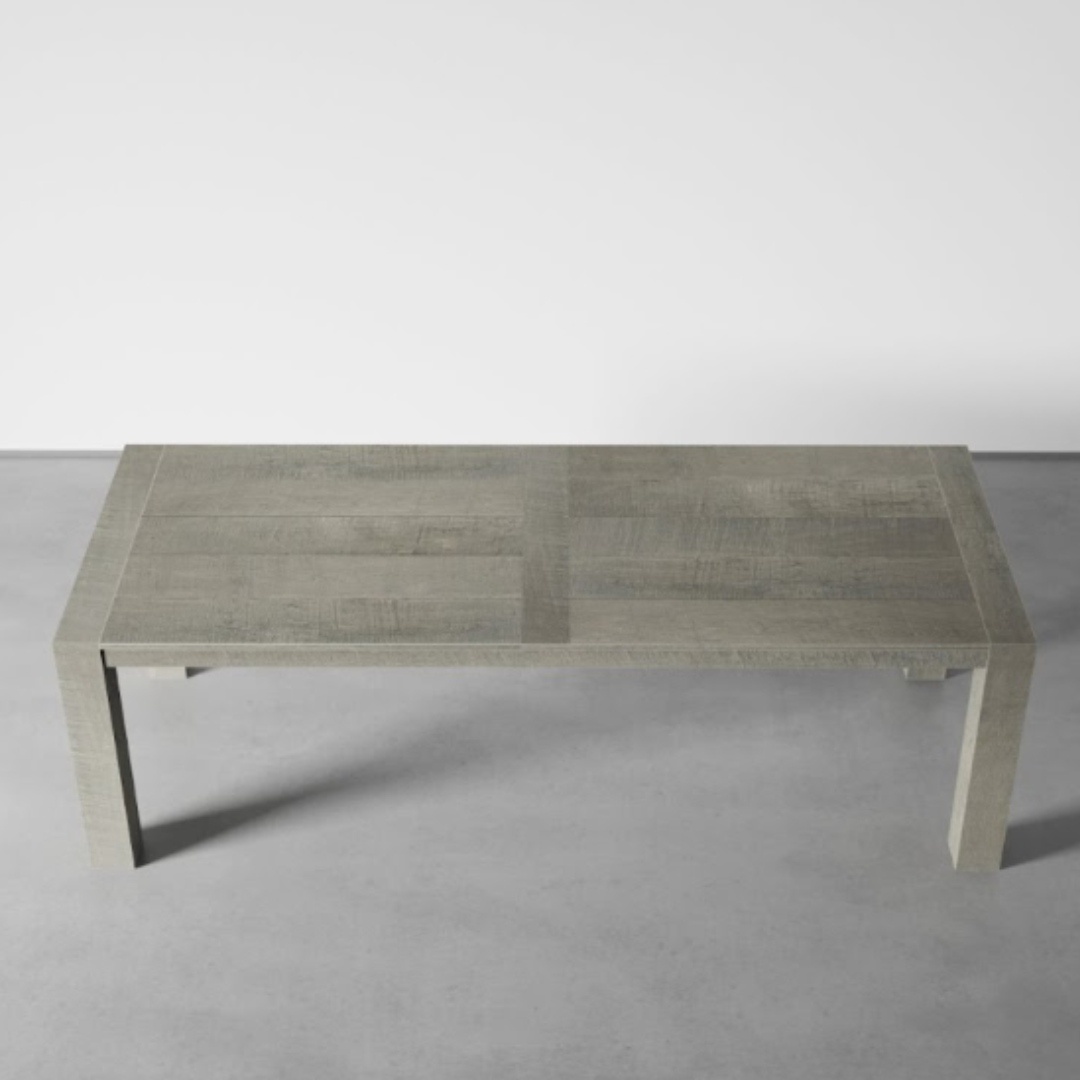 Villa Dining Table ( Rustic Grey) 70 _ 98 - 1 A grey rectangular wooden villa dining table with a minimalist design stands elegantly on a light grey concrete floor, adding a touch of rustic charm.