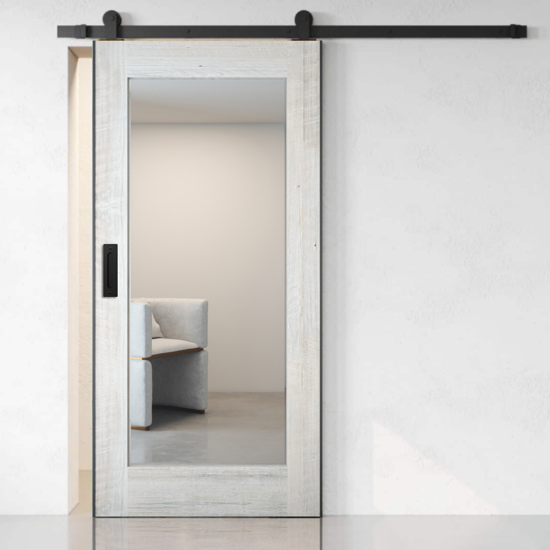 A Beveled Mirror Barn Door (White Wash), partially open to reveal a minimalistic room with a light-colored chair.