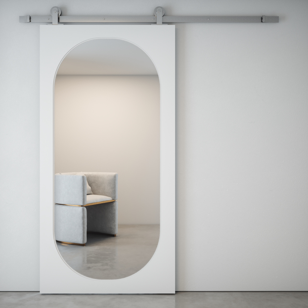 CELINE OVAL MIRROR BARN DOOR (silver hardware) - Main A Celine Oval Mirror Barn Door in white and silver reflects a modern armchair in a minimalistic room.