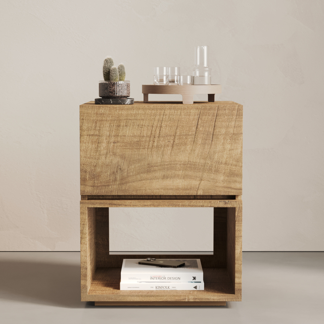 The Burma Nightstand, made of wood, features an open shelf stocked with books; the top surface is adorned with a small potted cactus and a set of glassware.