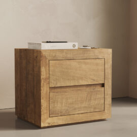 A Lugano Nightstand featuring a closed drawer, with a book and small items placed on top, set against a beige wall and grey floor.