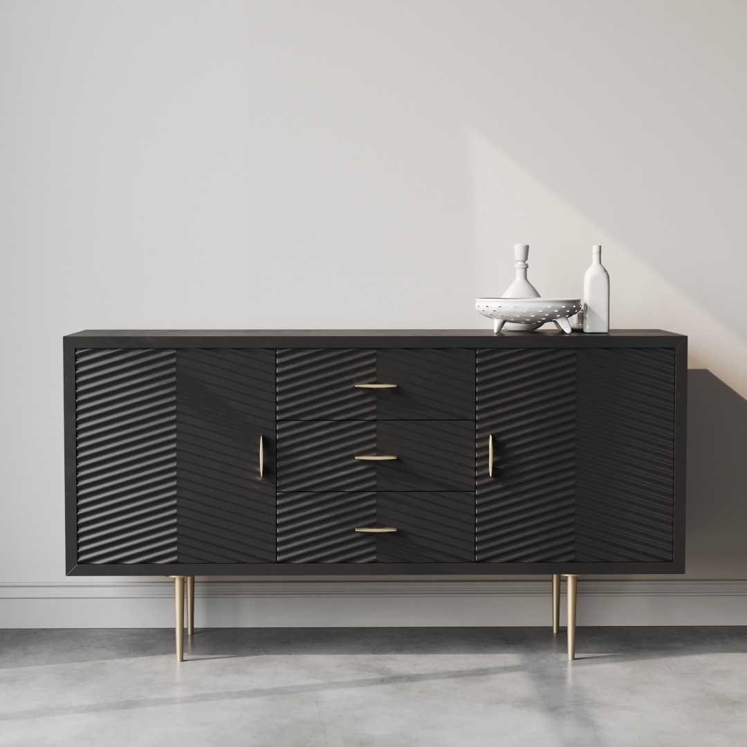 Placed against a plain white wall, the Arista 60" Side Cabinet (Black) boasts a textured diagonal pattern with gold handles and legs. On top of it sit two decorative vases and a small white tray.