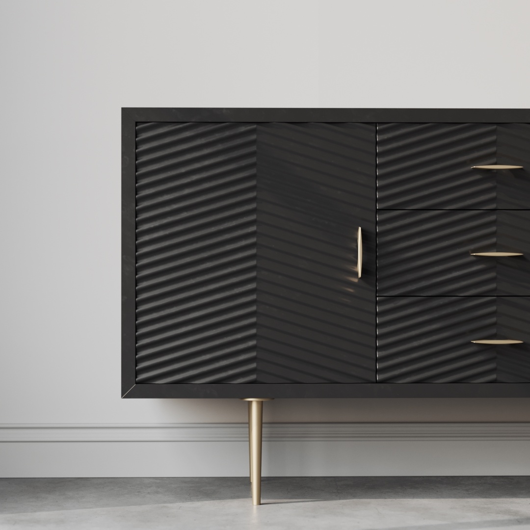 Arista 60 Side Cabinet Black -d The Arista 60" Side Cabinet in black, boasting gold legs and handles, three drawers, and a ribbed-textured door, stands against a light gray wall on a concrete floor.