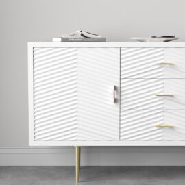 The Arista 60" Side Cabinet in White Wash boasts a modern finish with textured doors, complemented by elegant gold legs and handles. Its spacious width makes it ideal for stylishly displaying items like a book or dish on top.