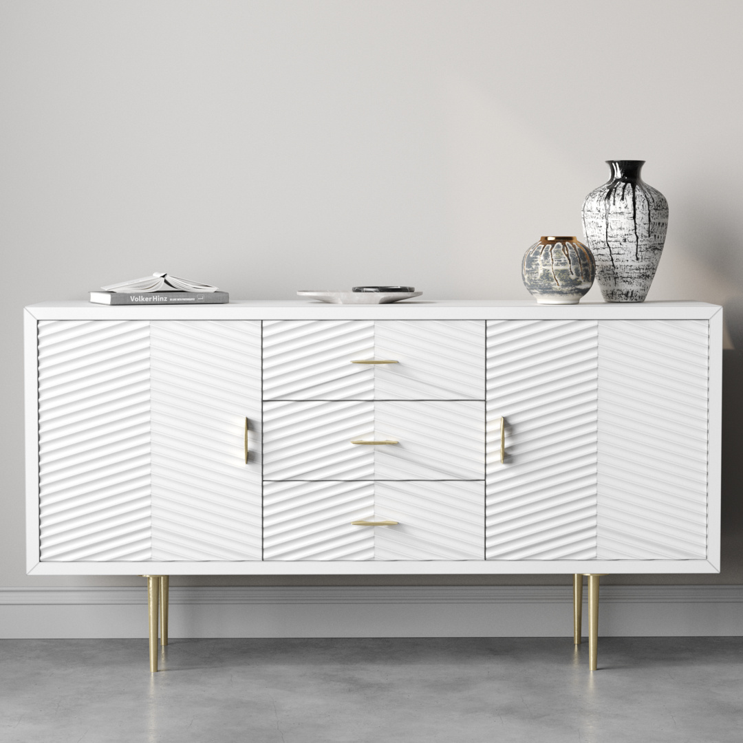 Arista 60_ Side Cabinet 5 The Arista 60" Side Cabinet in its white wash finish features textured doors and gold handles, making it a stylish focal point. Accented with two vases and a book, it stands gracefully against a light gray wall, exuding sophistication.