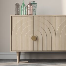 Introducing the Azul 58" Side Cabinet, a stunning piece crafted from light wood. This cabinet features elegant arched patterns on its doors, supported by two sturdy legs, and is adorned with circular knobs. To complete the look, four decorative glass bottles in various colors and an Azul hue are beautifully displayed on top.