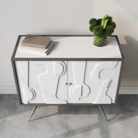 A modern side table featuring a white patterned front, two books, and a green plant in a clear vase placed on top of it. Reminiscent of the Estrella 60" Cabinet's sleek design, this table stands on angled metal legs.