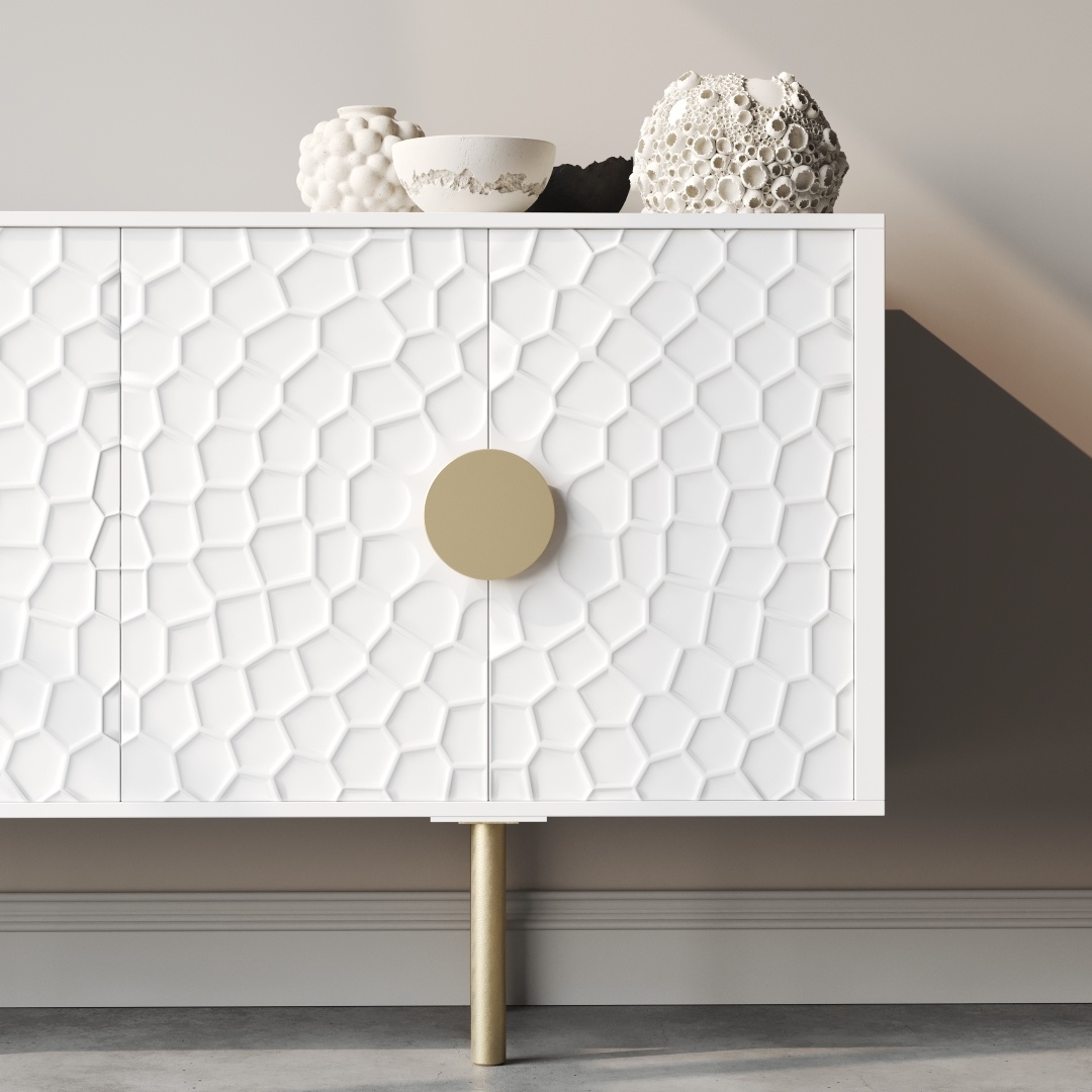 Luna 60 Side Cabinet-b The Luna 60" Side Cabinet showcases a modern white design with a honeycomb pattern on the doors and round golden handles. Decorative white vases sit atop the cabinet, beautifully complementing the neutral wall background.