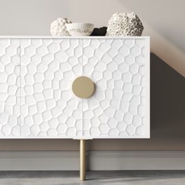 The Luna 60" Side Cabinet showcases a modern white design with a honeycomb pattern on the doors and round golden handles. Decorative white vases sit atop the cabinet, beautifully complementing the neutral wall background.