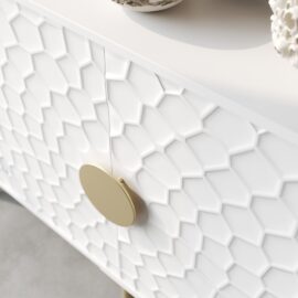 Close-up of the Luna 60" Side Cabinet featuring a white textured surface with a geometric honeycomb pattern and a circular golden handle.