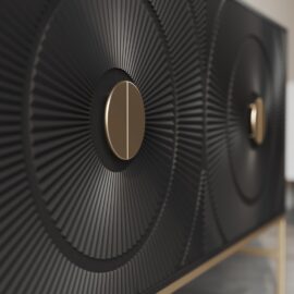 Up-close view of the Orbita 60" Side Cabinet door showcasing its intricate black and gold textures, adorned with circular sunburst-patterned designs, and centered with elegant gold knobs.