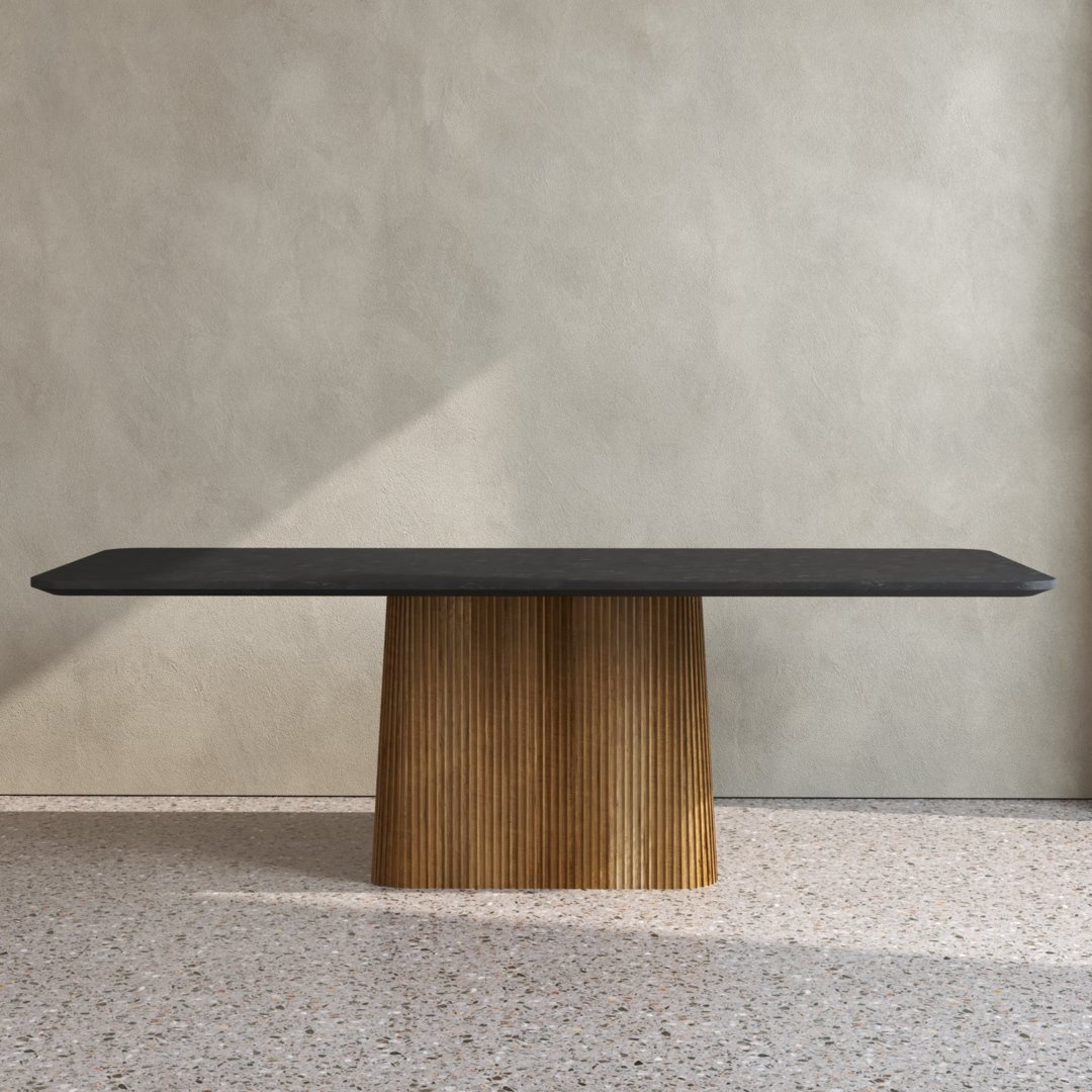 The Osaka Dining Table, featuring a black top and a wooden cylindrical base, is positioned against a light-colored wall on a terrazzo floor.
