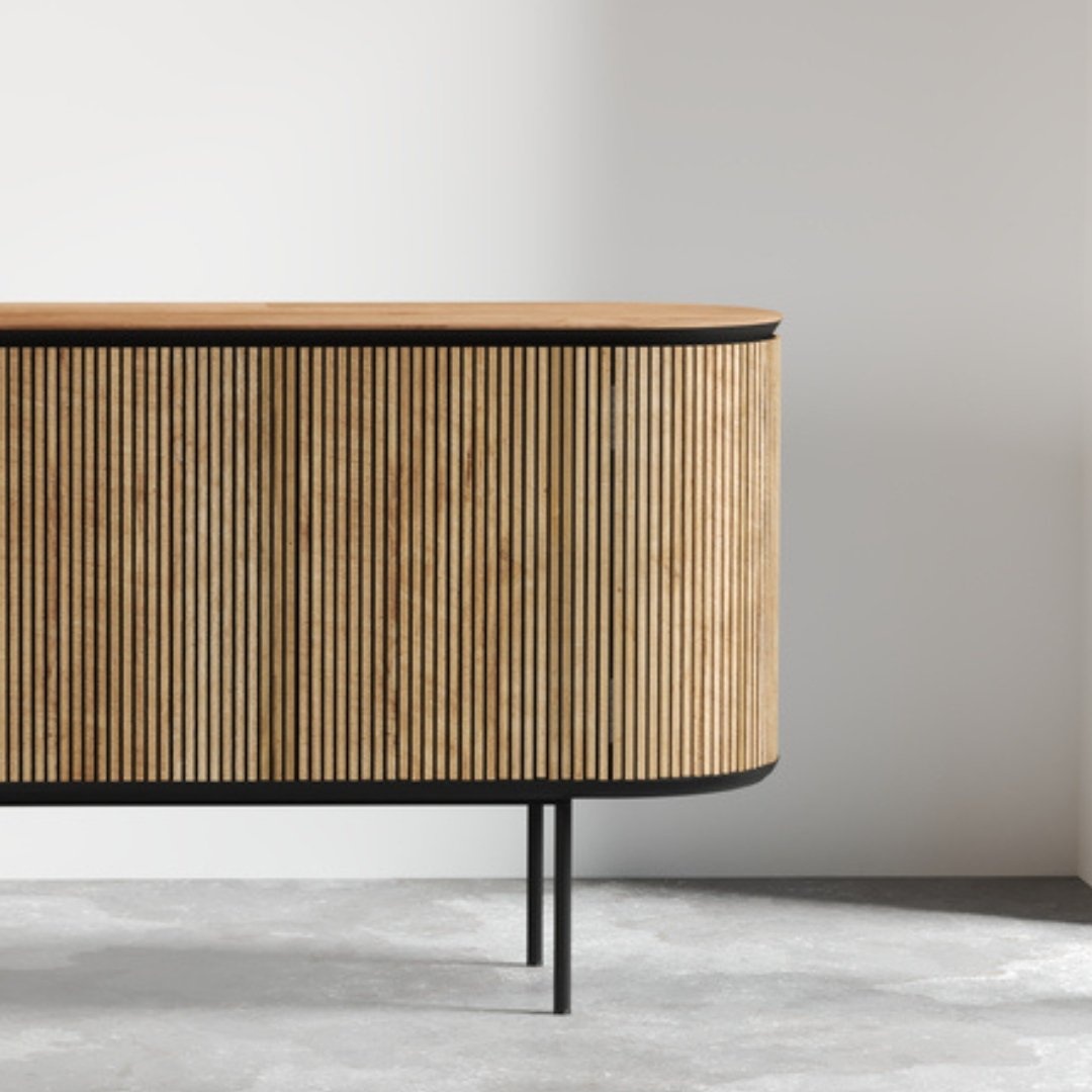 Untitled-design-3.jpg The Bolivar Dining Buffet features vertical slats, black edging, and black metal legs, set against a plain white wall.