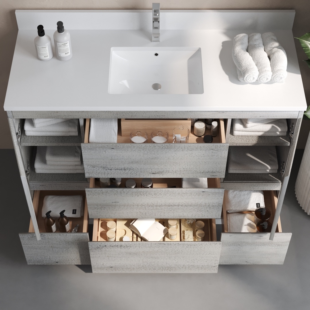 The Vamo 48" Single Sink Bathroom Vanity offers a sleek, contemporary look with an open drawer system that neatly organizes toiletries, folded towels, and various personal care items. The countertop includes a single sink vanity adorned with bottles and rolled towels.