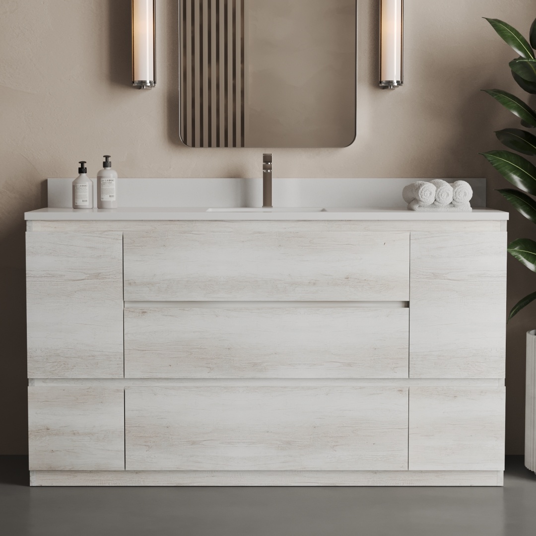 The Vamo 60" Single Sink Bathroom Vanity showcases a sleek modern design, complemented by a pristine white countertop. The vanity is accented with dual wall sconces, a rectangular mirror, and minimalist décor elements such as a green plant and neatly rolled white towels.
