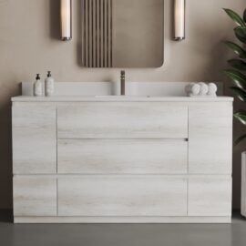 The Vamo 60" Single Sink Bathroom Vanity showcases a sleek modern design, complemented by a pristine white countertop. The vanity is accented with dual wall sconces, a rectangular mirror, and minimalist décor elements such as a green plant and neatly rolled white towels.
