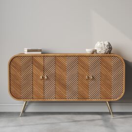 The "Vista 60" Side Cabinet" showcases a striking chevron pattern and stands on gleaming gold legs, with two books and a round decorative object carefully placed on top.