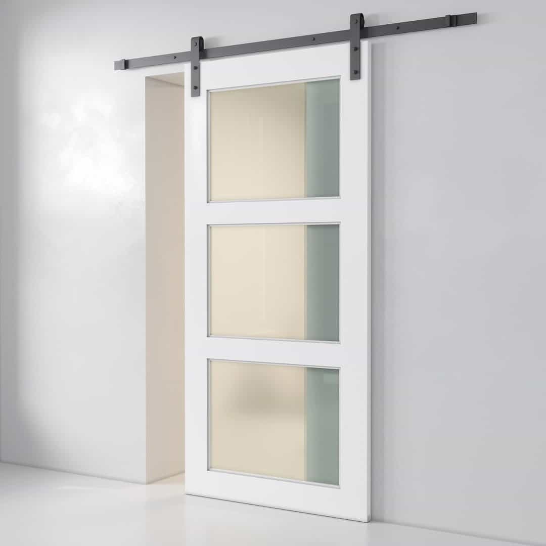 A 3-Panel Frosted Glass Barn Door, featuring three frosted glass inserts, is mounted on a sleek metal track against a plain white wall.