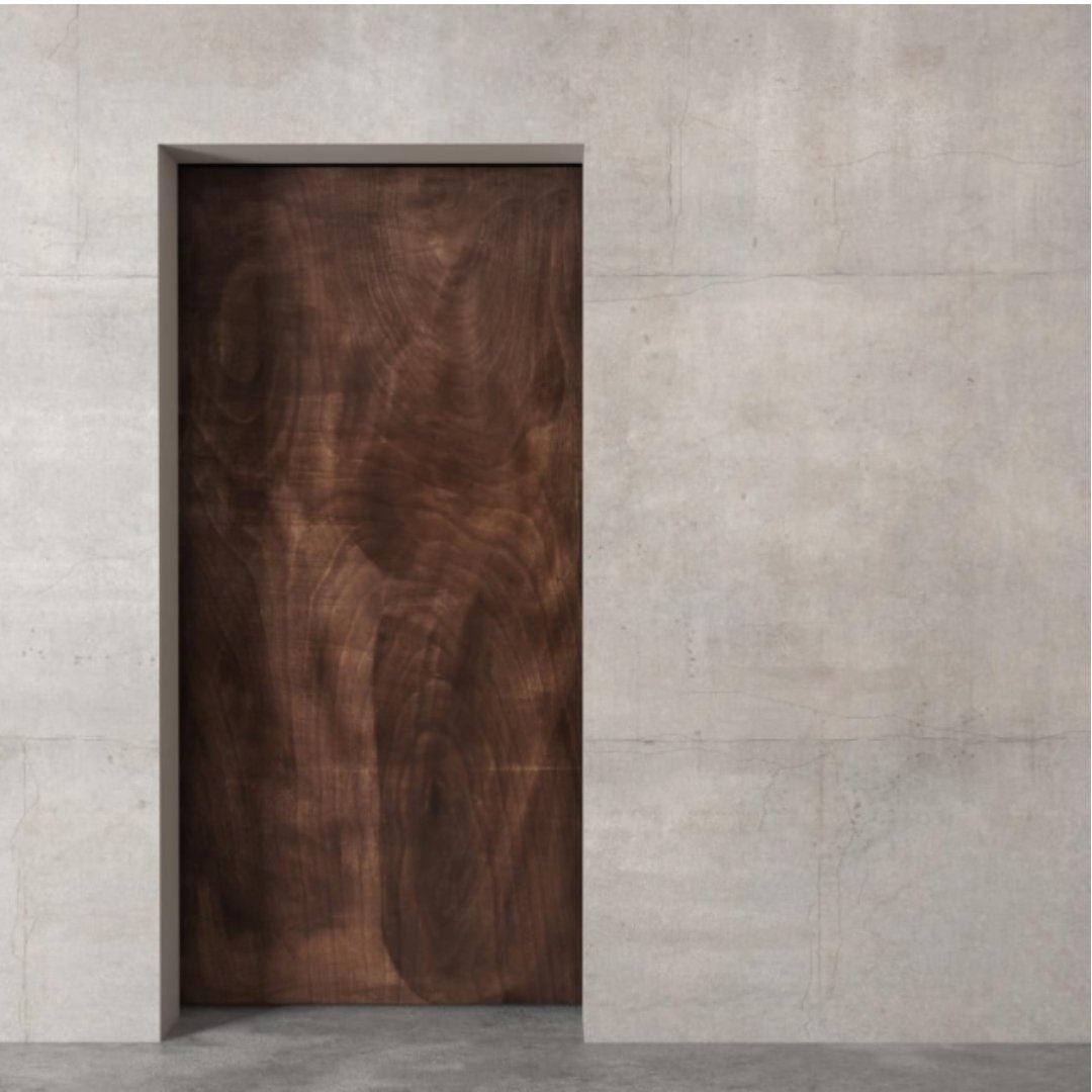 BEVELED-RECLAIMED-WOOD-MIRROR-BARN-DOOR-Espresso-Finish-2.jpg The Alchemist Herringbone Barn Door, a wooden door set within a concrete wall, creates a minimalist architectural design.
