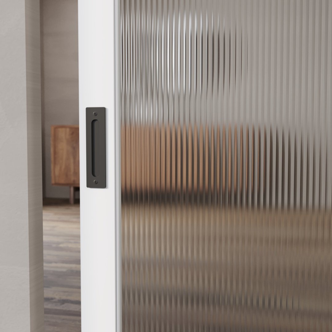A Celine Oval Ribbed Glass Barn Door with a black handle is partially open, offering a hazy glimpse of a wooden cabinet in the background and adding an elegant touch to the barn door aesthetic.