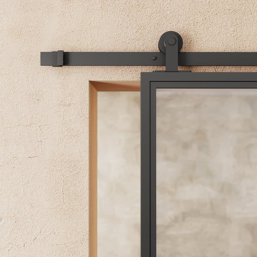 FC-1-PANEL-2.jpg A close-up view of the French Casement 1-Panel Barn Door mounted on a beige wall, showcasing the metal track and roller mechanism.