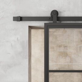 Close-up of the French Casement 4-Panel Barn Door featuring a sleek black metal frame, mounted on a wall with a visible black sliding mechanism. The background wall has a textured, light-colored finish.
