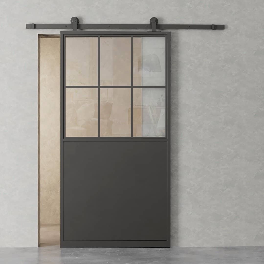A closed French Casement 7-Panel Barn Door with a black frame on a light gray wall, revealing part of the adjacent room.