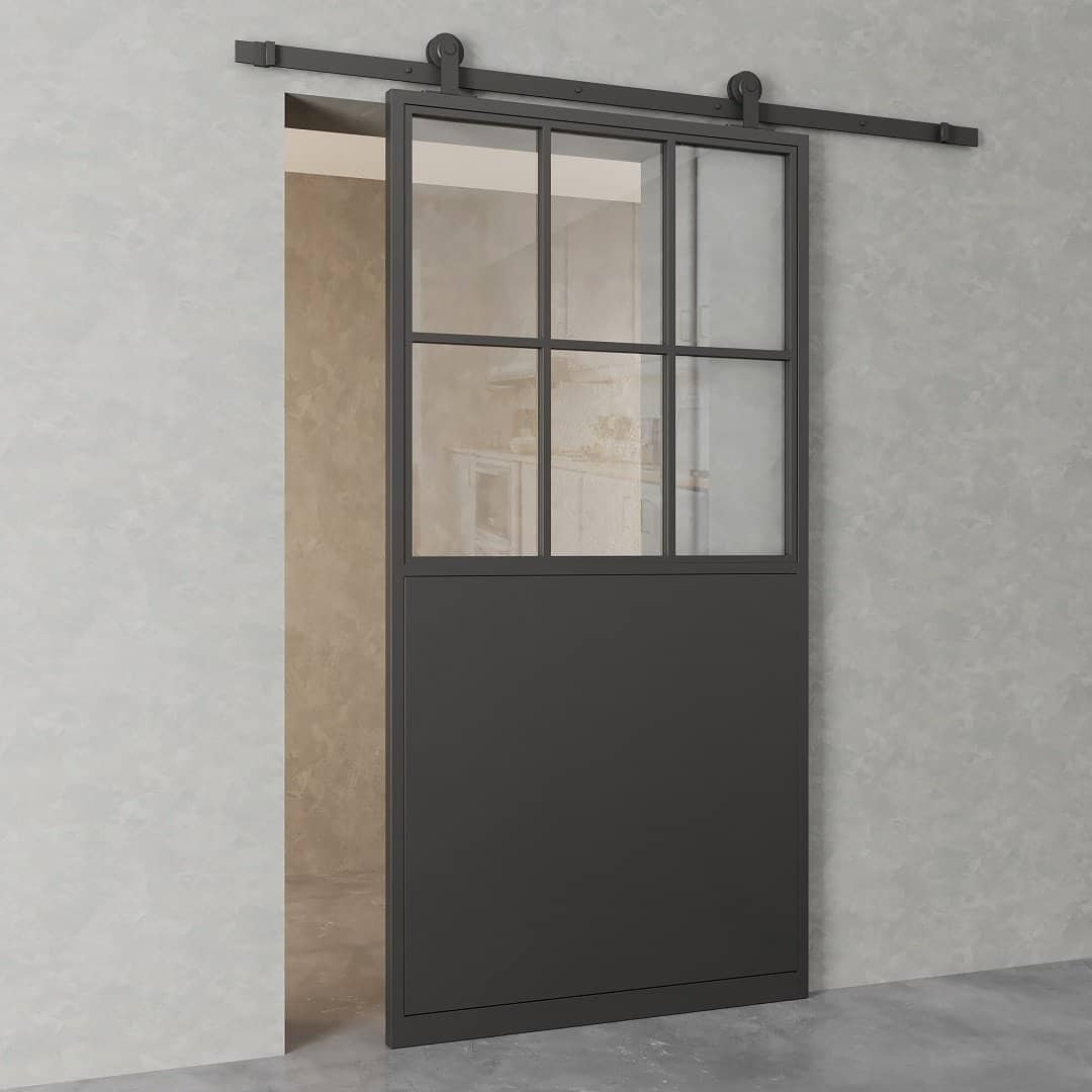The French Casement 7-Panel Barn Door, featuring a black metal frame and divided glass panes, is partially open against a light gray wall.