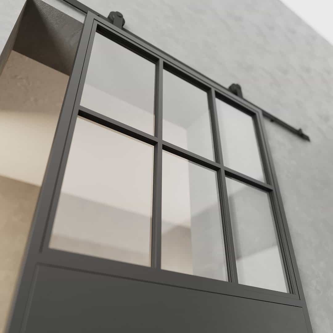 FC-7-PANEL-3.jpg A French Casement 7-Panel Barn Door with a black frame and glass panels, mounted on a gray wall.