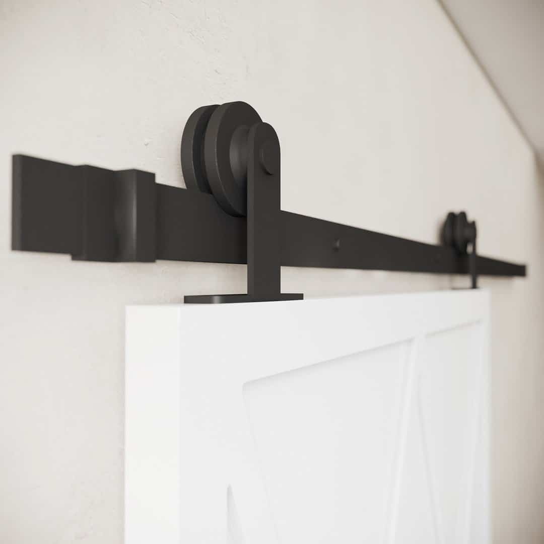 LYNX-WHITE-4.jpg Close-up of the Lynx Barn Door black metal sliding hardware set mounted on a white wall with a partially visible door.