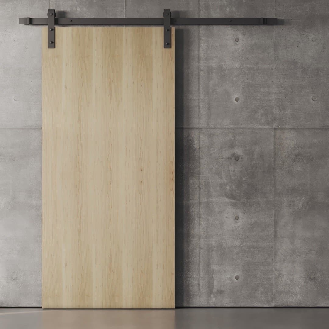 A Nordic Barn Door with black metal hardware installed on a gray concrete wall.