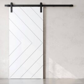 The Prestige Barn Door, featuring a white finish with diagonal lines, is mounted on a black metal track against a light-colored wall.