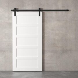 A 5-Panel Barn Door, featuring five rectangular sections in white, is mounted on a black sliding barn door track against a plain, gray concrete wall.
