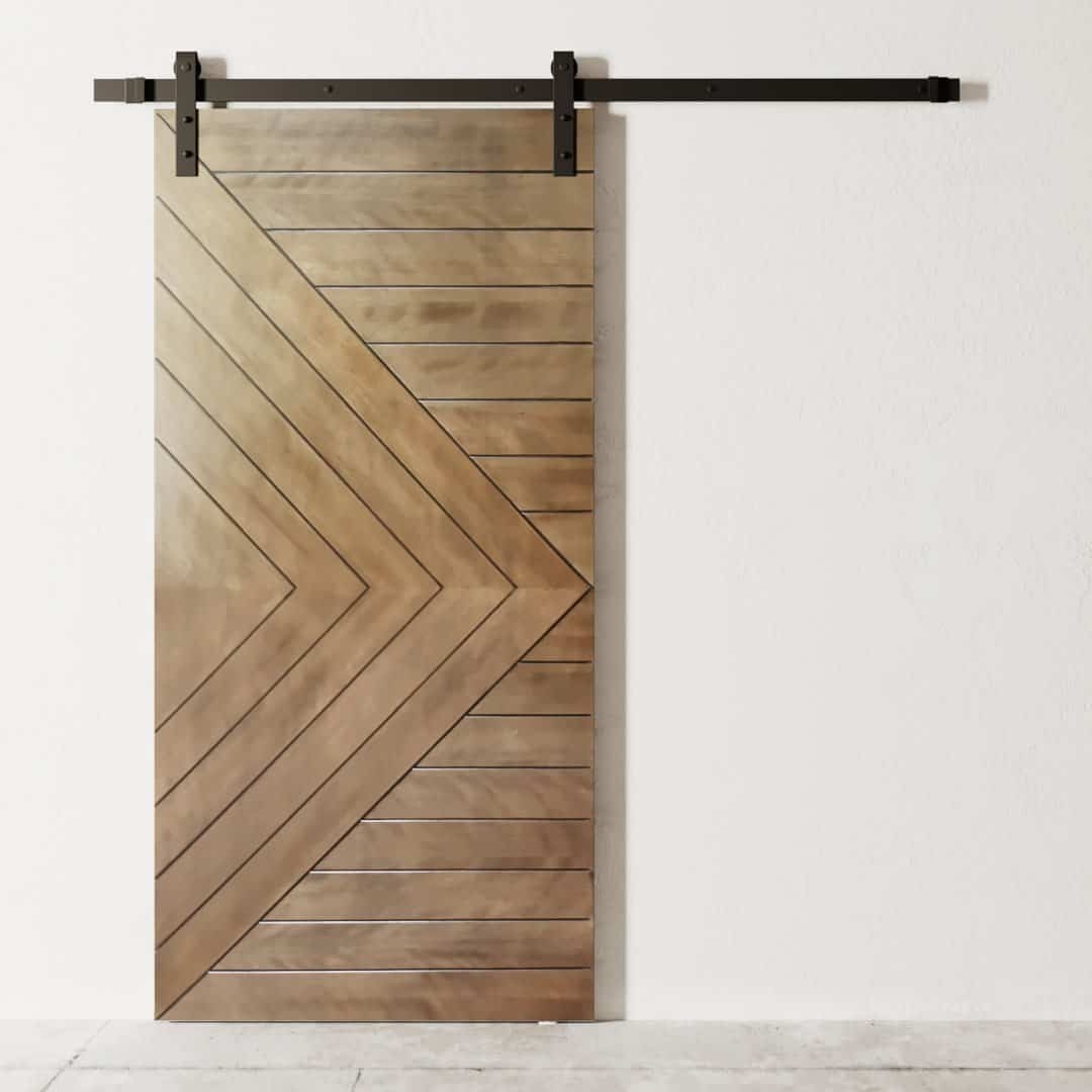 The Dawson Barn Door, featuring a chevron pattern design, is mounted on a black metal track against a white wall.