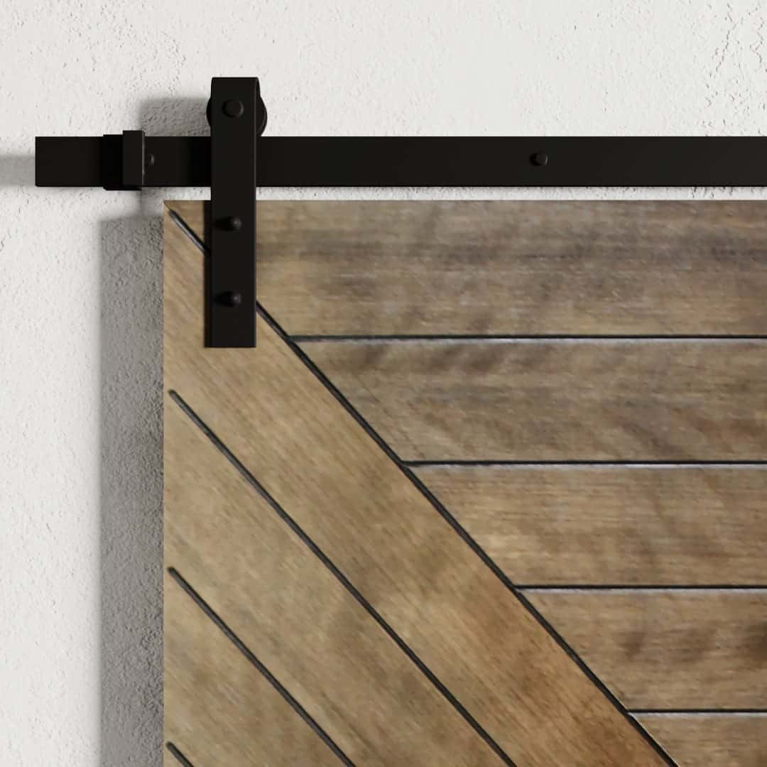 Urban-Woodcraft-Dawson-Barn-Door-African-Mahogany-3.jpg Close-up of the Dawson Barn Door featuring diagonal wood paneling and a black metal track, mounted on a white wall.