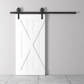 The Grand X Barn Door, a white wooden design equipped with a black sliding track, is mounted on a light gray wall above a concrete floor.
