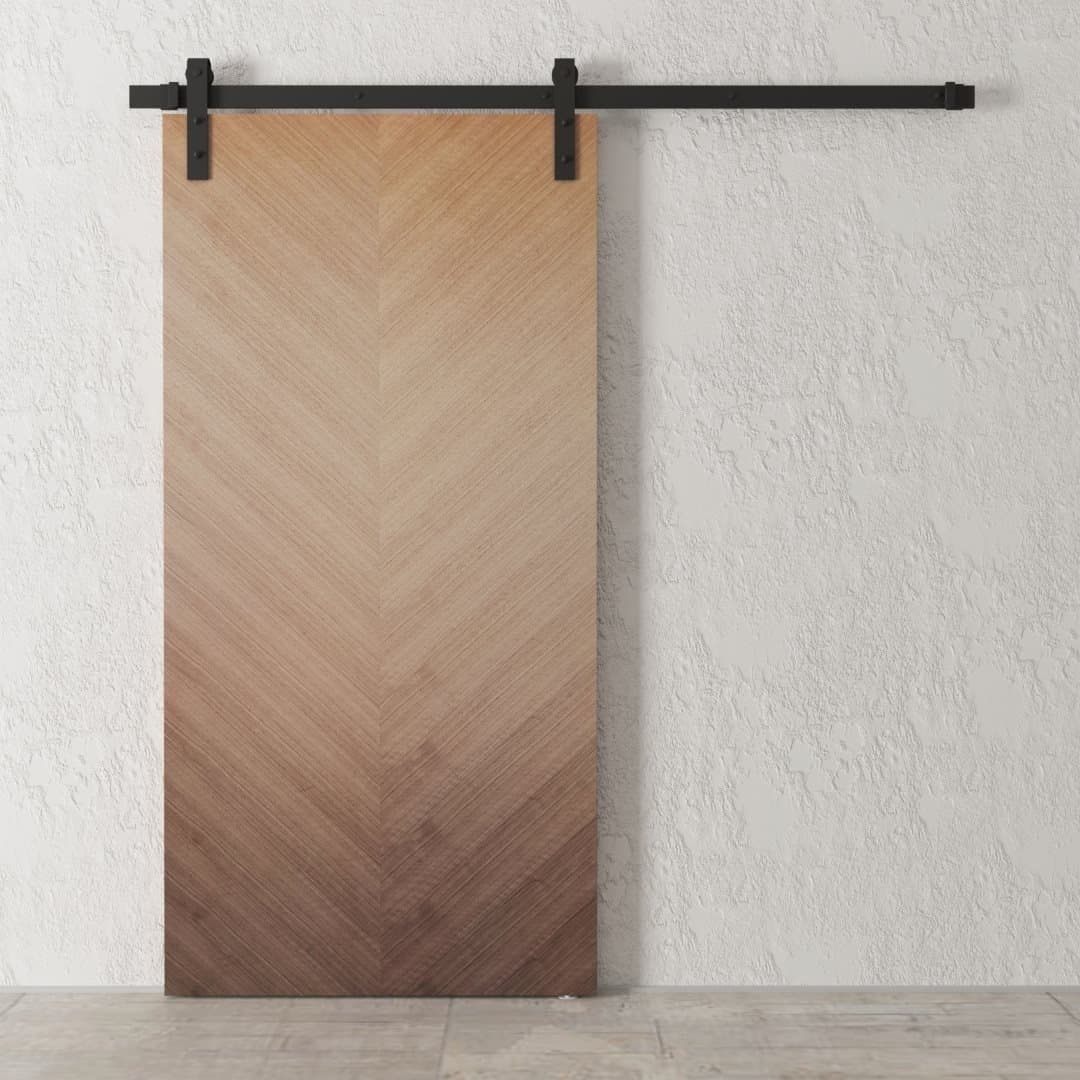Havana Barn Door with a chevron pattern, mounted on a black metal track against a textured white wall.